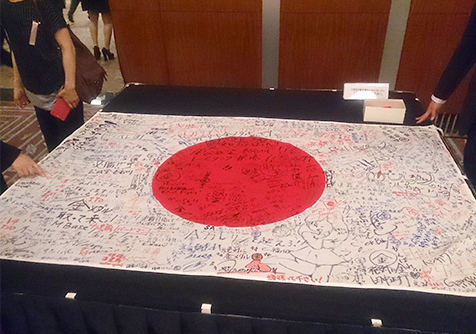 Japanese flag covered in messages of support (at the send-off in Tokyo)